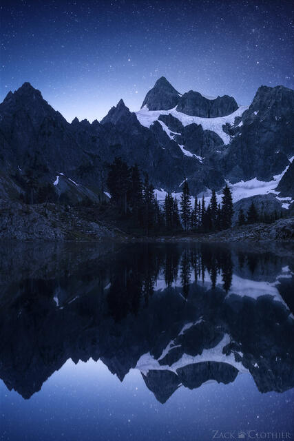 Stars in the night sky over Mount Shuksan and Lake Anne, Mount Baker Wilderness, Washington