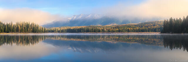 Swan Range reflecting in a pristine lake in western Montana at sunrise