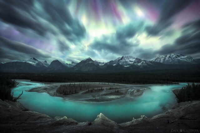 Auroras dancing above the Athabasca River in Jasper National Park in the Canadian Rockies