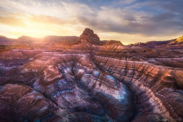 Layers of colorful badlands in a remote part of Utah at sunset