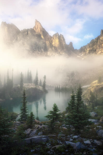 Foggy morning in remote alpine cirque in the Idaho Rocky Mountains at sunrise