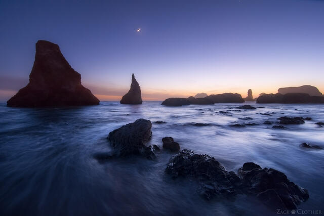 Wizard's Hat and other sea stacks silhouetted at twilight along the pacific coast, Bandon Beach, Oregon